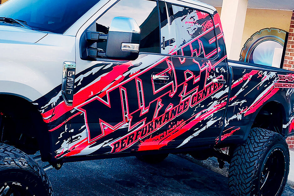 Pick-up truck with vibrant red and black graphics printed on a Roland DG TrueVIS VG2 printer/cutter.