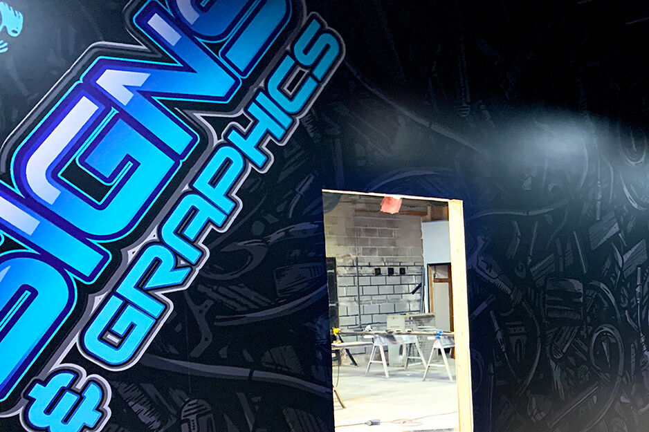 Wall wrap with logo for J Signs & Graphics printed on their Roland DG TrueVIS VG2 wide-format printer/cutter.