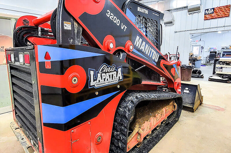 Bobcat earthmover with red, white and blue custom graphics wrap.