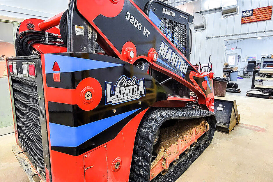 Bobcat earth mover with red, white and blue graphic designs.