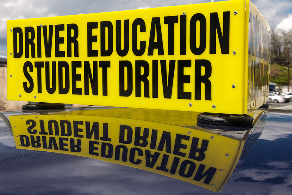 Sign atop a car says "Driver Education Student Driver," printed using a Roland DG TrueVIS VG2 printer/cutter