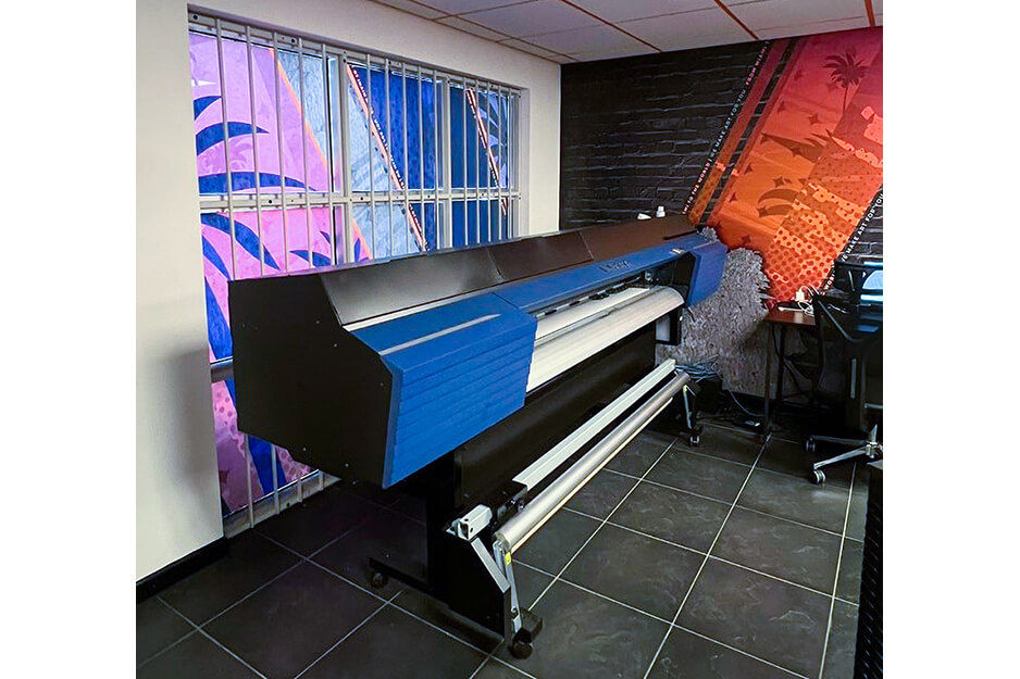 Roland DG TrueVIS digital printer cutter shown in a room with custom-printed designs on the walls.