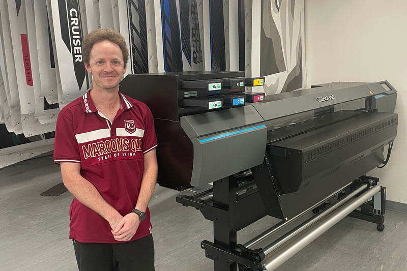 Custom Striping owner Ryan Smith standing next to his TrueVIS AP-640 resin ink printer.