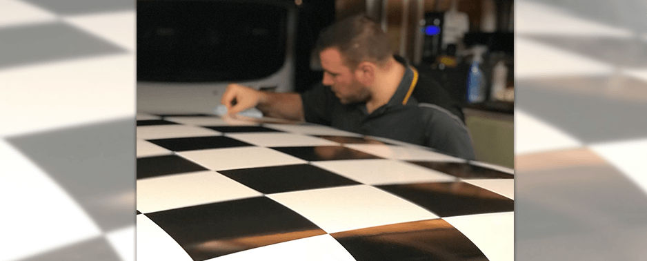 Applying chequered graphic to the roof of a car