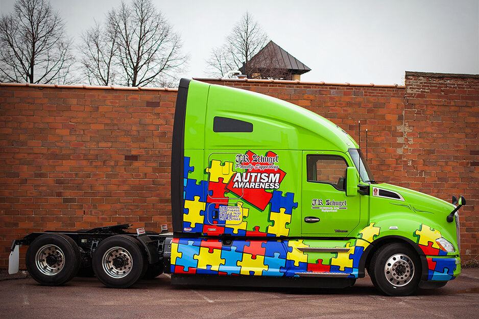 A semi-trailer cab wrapped in colorful graphics printed by Fuel Graphics on its Roland DG TrueVIS VG2-540 digital printer/cutter.