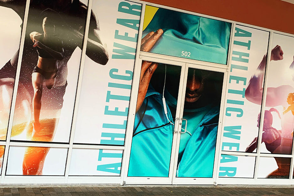 Colorful window graphics produced on Inked Vinyl's Roland DG TrueVIS VG2-640 wide-format printer-cutter completely cover some retail windows in local mall.