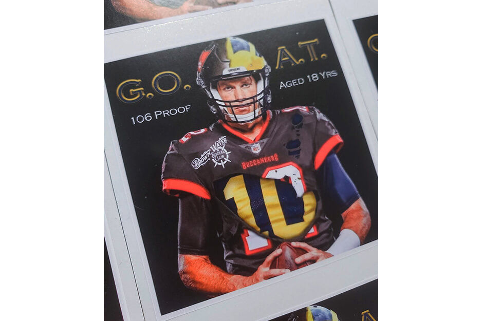 Just Fab Graphics produced these custom whiskey bottle labels featuring Tom Brady as the G.O.A.T. on its Roland DG TrueVIS VG2-540 digital printer/cutter.